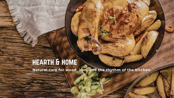 Roasted chicken in a cast iron pan on a cutting board with potatoes, with 'Hearth & Home' branding.